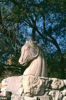 Statue of horse on exterior stone wall 