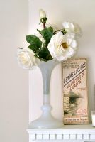 Vase of white roses on mantelpiece detail 