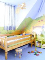 Childrens room with colourful wall murals 