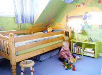 Child playing in colourful bedroom 