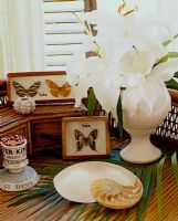 Collectibles and flowers on wicker table