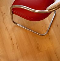 Detail of dining chair on wooden floor 