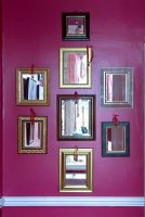 Display of mirrors on colourful wall 