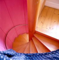 Modern spiral staircase with colourful walls 
