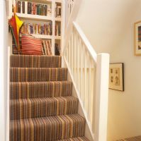 Modern staircase with striped carpet 