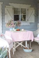 Garden table and chairs on summerhouse porch 