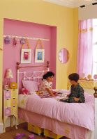 Chidren playing together in modern bedroom 