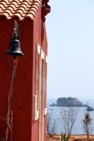 Vintage bell on side of coastal building 