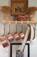 Shelf in country kitchen with copper pans 