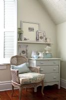 Vintage chest of drawers and chair in bedroom 