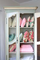 Vintage cabinet full of cushions and fabrics 