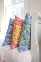 Detail of colourful cushions on bed 