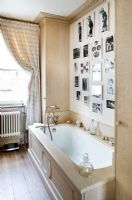 Classic bathroom with feature wall of photos 