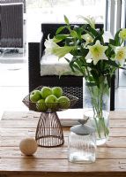 White Lilies on wooden dining table