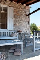 Stone patio with wooden furniture
