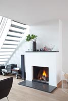 Modern fireplace under stairs