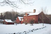 Wooden country home in snow
