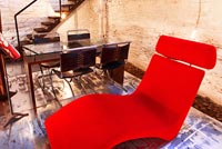 Red chaise lounge in dining room