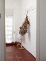 Dried flowers hanging from coat hooks