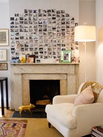 Display of photos above classic fireplace