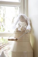 Enamel urn and white rag doll