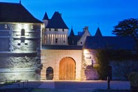 Entrance to castle lit up at night - Chateau du Riveau