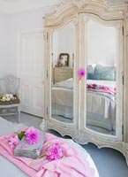 French style bedroom with mirror fronted wardrobe