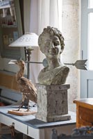 Classical stone bust and weather vane