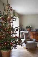 Striped armchair next to christmas tree