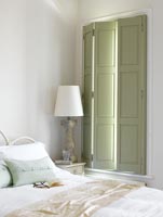 Classic bedroom with green shutters