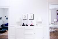 White sideboard with Ikea lamps and ornaments in bell jars