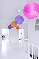 Contemporary landing with colourful paper light shades