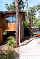 Contemporary wooden house surrounded by trees
