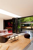 Contemporary living room and garden lit up at night