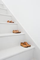 Vintage shoe lasts on white stairs