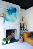 Classic fireplace with abstract painting