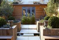 Modern garden with water feature and raised beds