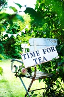 Time for tea sign on garden chair 