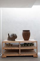 Ceramics by Cathérine Clarysse displayed on wooden shelves