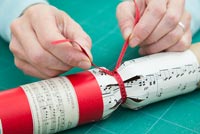 Step by Step guide for making Christmas Crackers from scratch - tying on ribbon