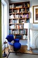 Blue armchair by bookcase