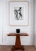 Black and white print hung above classic table