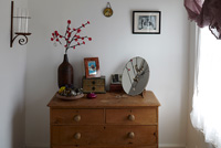 Jewellery and ornaments on chest of drawers