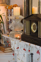 Ornate mantlepiece with stone candlesticks