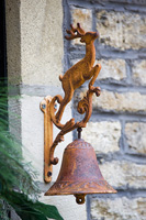 Rusty iron door bell with deer motif

