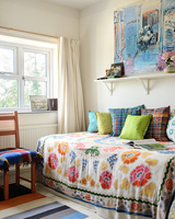 Colourful cushions and bedspread