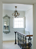 Classic landing with vintage chandelier and reclaimed iron  bannisters
