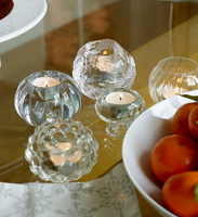 Tea light holders on glass dining table