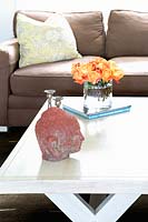 Vase of orange Roses on coffee table