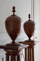 Classic wooden urns on plinths